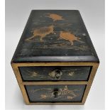 Japanese gilded black lacquer small two drawer chest, the lid painted with three terrapin, width 4.