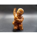 Chinese carved boxwood figure of a boy Buddhist Monk holding a peach, height 2.75in