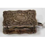 Victorian silver vinaigrette, of rectangular serpentine form, foliate scroll engraved, foliate