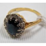 18ct gold diamond and sapphire cluster ring, the dark oval cut sapphire surrounded by chip diamonds,