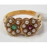 Attractive 9ct gold ring designed as two intertwined hearts set with seed pearls, an emerald and