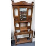 Edwardian oak hall stand with rectangular bevel edged mirror over a single drawer and on barley