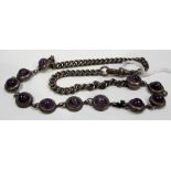 Hallmarked silver necklace with eleven collet set amethyst cabochons, length 38cm (one link