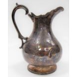 Victorian Irish silver pedestal jug of pear form with strap work and foliate engraved decoration,