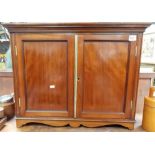 Edwardian table cabinet with pair of hinge doors over a shaped apron and bracket feet, width 26in