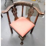 Carved oak corner chair with pierced vase splats.