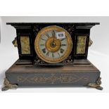 Black painted metal and simulated marble two train mantel clock, width 14in.