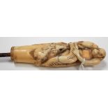 Japanese Meiji period carved ivory parasol handle modelled as a monkey sat on a rock with two