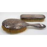 Two silver dressing table brushes.