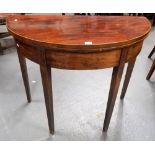 Early 19th Century mahogany boxwood strung demi-lune card table raised on four square tapering legs,