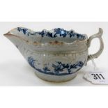 A Lowestoft 18th Century porcelain cream boat with moulded body and underglaze blue decoration