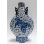 Chinese blue and white decorated porcelain moon flask with twin lug handles, decorated to both sides