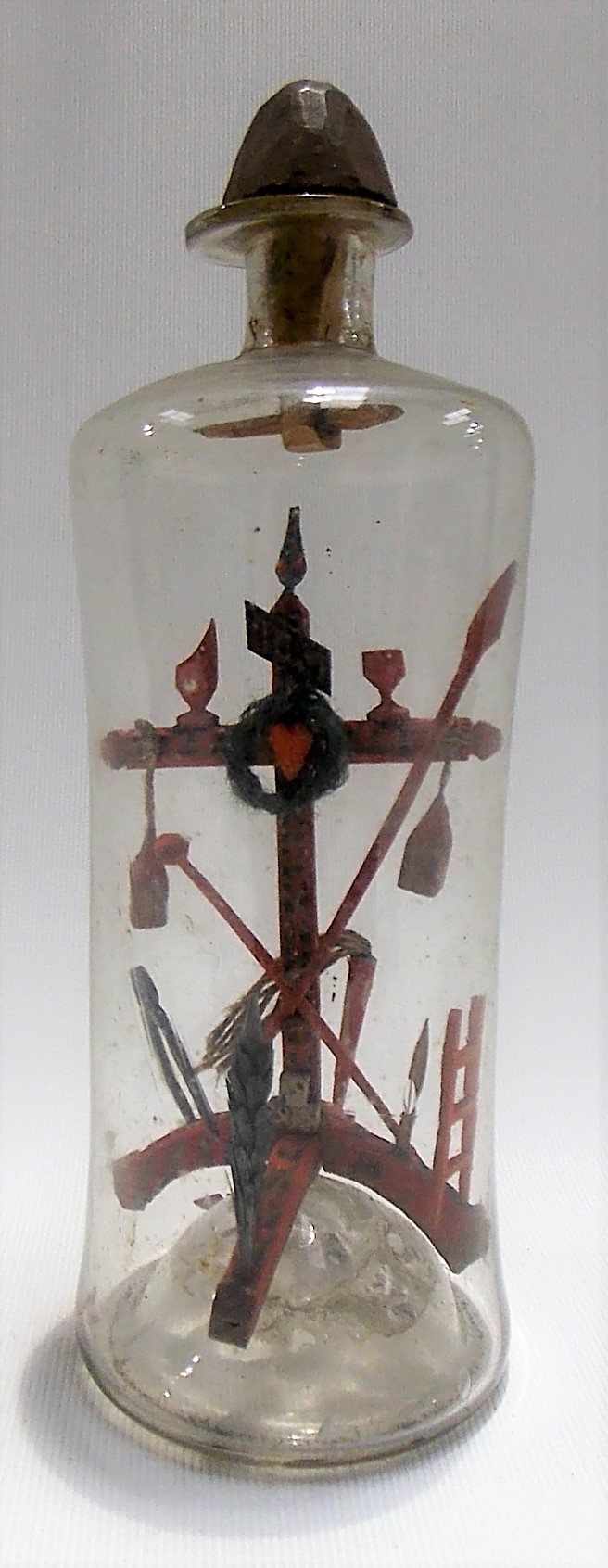 19th Century carved and painted stickwood cross in a bottle with applied religious emblem, folk art,