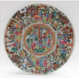 Cantonese famille rose charger decorated with numerous figures within interiors and gardens,