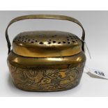 Chinese brass hand warmer with swing handle, the pierced lid with incised peach, the sides with