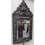 A small Dutch brass framed embossed bevel edged wall mirror, height 17in (frame af)