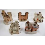 Two Victorian Staffordshire pottery cottage pastille burners together with three castle pastille