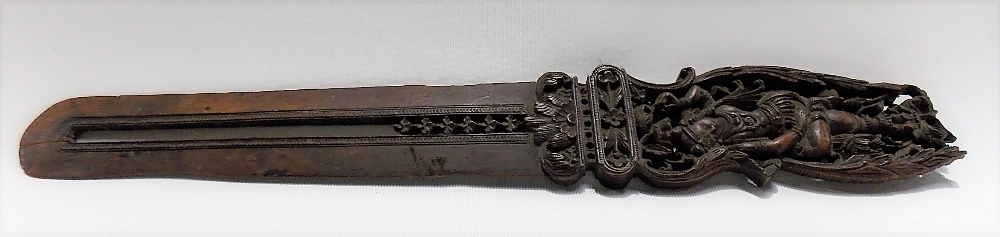 An Indian carved and pierced wood page turner, the handle carved to both sides with female