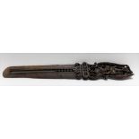 An Indian carved and pierced wood page turner, the handle carved to both sides with female