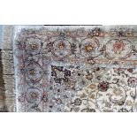 20th Century Persian silk and wool mix rug with central medallion and foliate scroll surround and