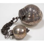 Eastern white metal ovoid hinge lidded box, foliate engraved with loop and chain attached to a small