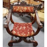 19th Century Italian walnut X-frame chair with foliate scroll carved top rail and upholstered back