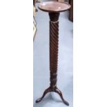 Mahogany leaf carved and wrythen fluted torchiere upon three outswept legs, height 52in