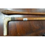 Possibly a tribal throwing club, with bulbous scratch carved end, length 42'; together with a