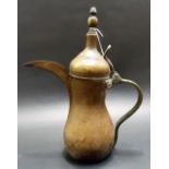 Arabic brass coffee pot Dallah with hinged dome lid and finial and with beak-like spout, maker's