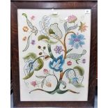 A crewelwork panel of foliate design within an oak frame, 25in x 19in.