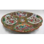 Cantonese famille rose oval lobed dish, typically decorated with four reserves of figures and