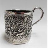 Indian white metal mug, embossed and chased with wolves, dogs and a tiger amongst foliage, weight