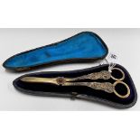 Good pair of Victorian silver gilt grape scissors, the cast handle with classical figures, the