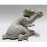 Chinese blanc de chine porcelain monkey reclining, holding aloft a peach, width 6.75in