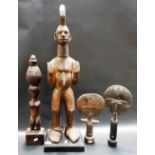 Two African standing tribal figures, the largest with an iron ring on his right foot; together