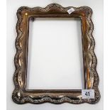 Edwardian silver mounted large rectangular photograph frame of shaped form and with foliate scroll