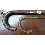 Two horse measuring walking canes, one with silver finial and collar, hallmarked London 1909 and