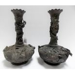 Pair of Chinese relief cast bronze bottle vases, the necks with a coiled dragon, the squat ovoid