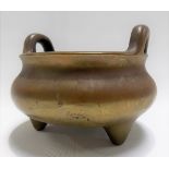 Chinese bronze incense burner with twin handles and raised on three feet, character mark to the