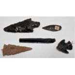 Three Obsidian arrow heads together with a fine leaf shaped blade and a stone arrow head