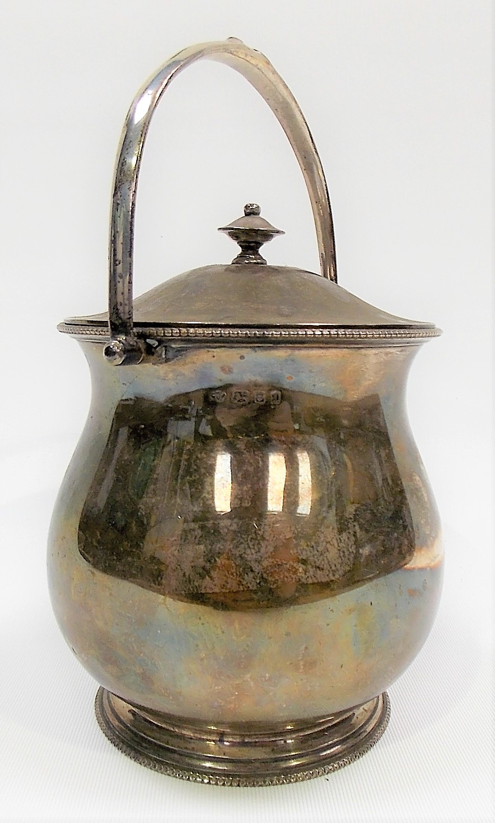 Silver lidded swing handled biscuit barrel of baluster form, maker B & F Ltd, London 1926, height