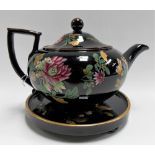 Early 19th Century Wedgwood black glazed teapot and foliate enamel decorated cover and stand,