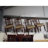 Set of four Victorian walnut dining chairs with stuff over seats and carved top rails.