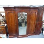 Victorian Mahogany break front triple robe with central mirror door enclosing four linen slides