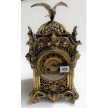 French ornate brass two train mantel clock, the case overall foliate scroll cast and pierced and