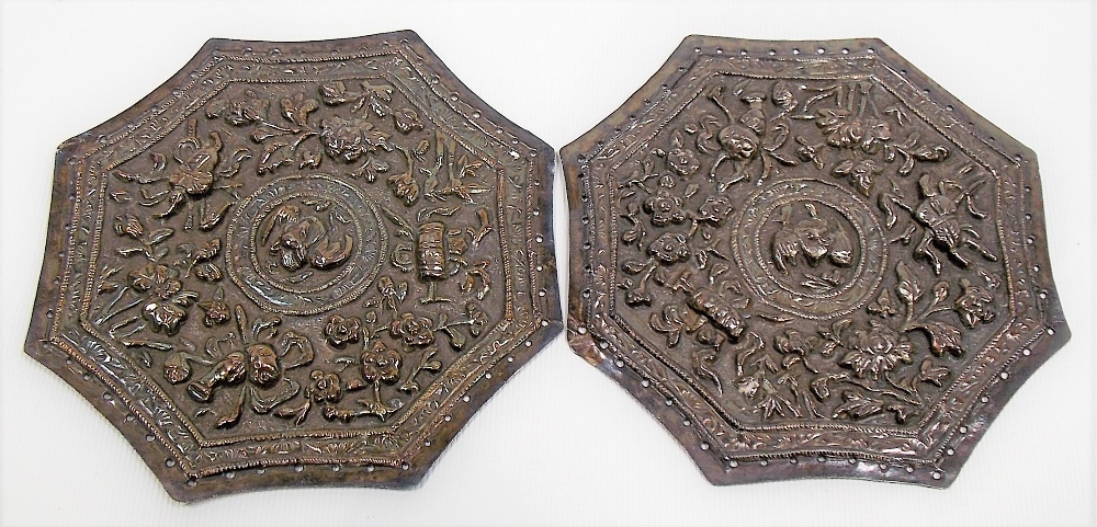 Pair of Chinese white metal octagonal embossed panels, each decorated with three auspicious motifs