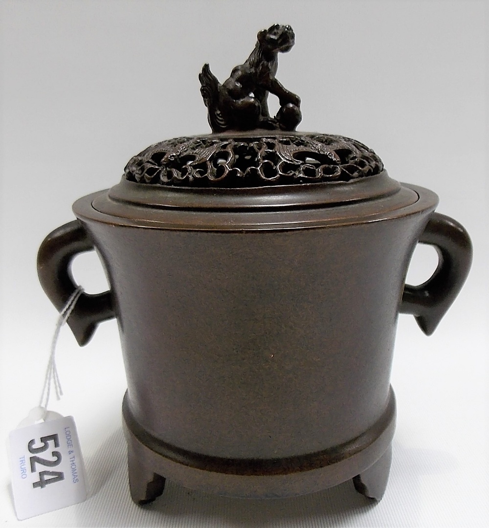 Chinese bronze lidded twin handled incense burner, the slightly domed lid with Fo dog with ball