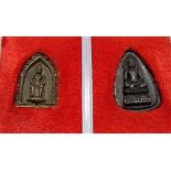 Two Tibetan miniature votive Buddha discs, both inscribed on the back, length 1in (2)
