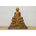 A Thai buddha sitting on a stepped pedestal (66cm)