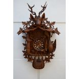 A very large Black Forrest clock in carved wood (26x72x125cm)